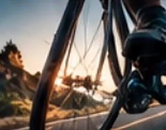 Cyclist on a road at sunset